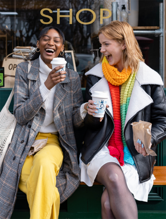 Two ladies laughing, drinking tea