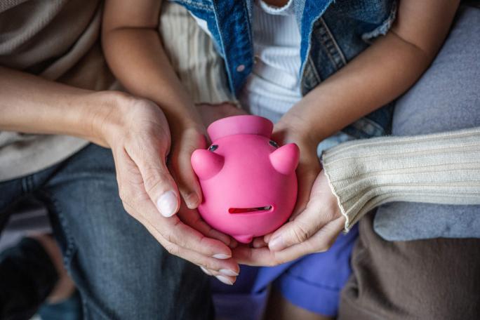 family-hands-holding-piggy-bank.jpg