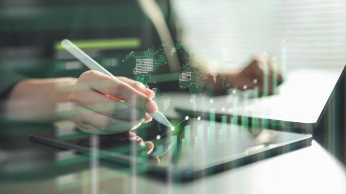 A hand using a digital pen on a tablet