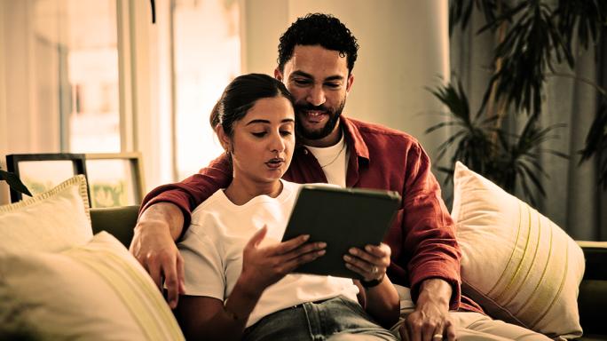 A couple looking up information on a tablet