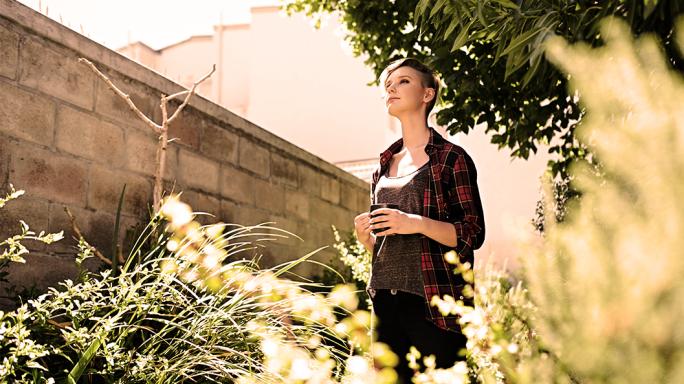 A lady in her garden thinking