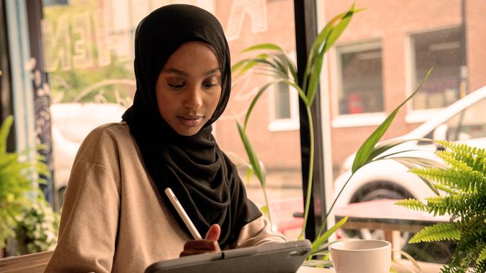 Lady in cafe looking at tablet