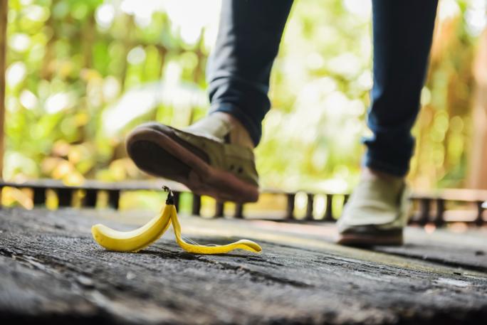 Man about to walk on banana skin
