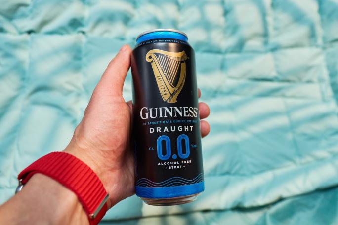A man holding a can of Guinness Zero