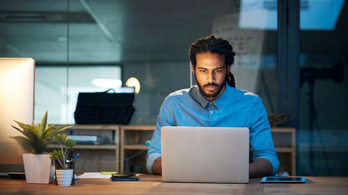 Man sitting looking at laptop