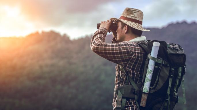 Man looking through binoculars