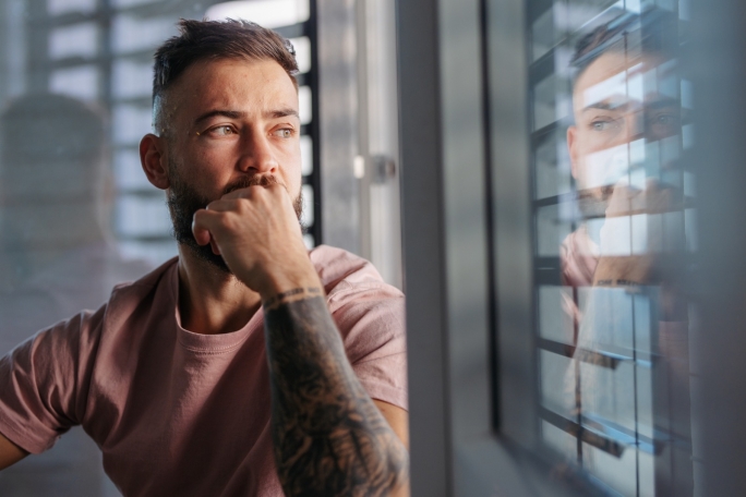 Man looking through window