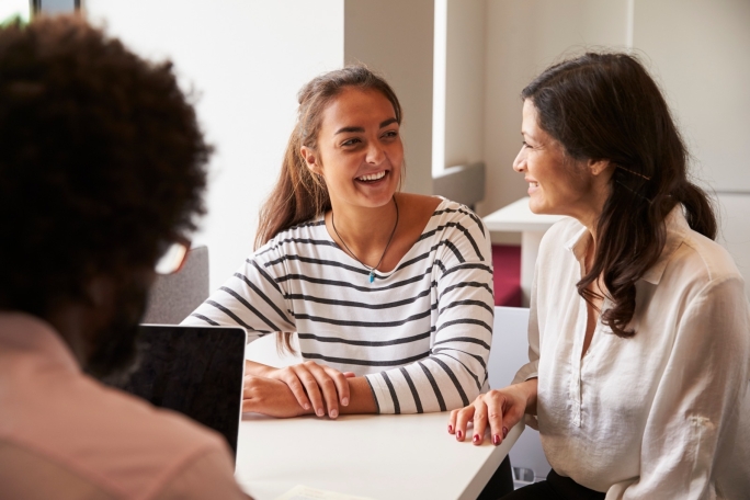 Mother And Daughter Meeting With Male Teacher