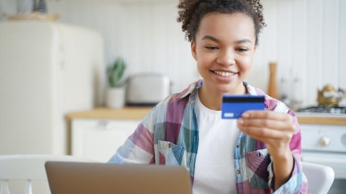 Teenager with a bank card smiling