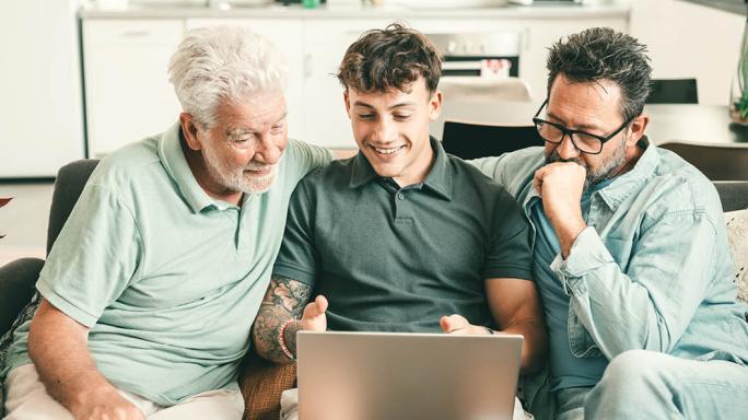 three generations of a family looking at a computer screen