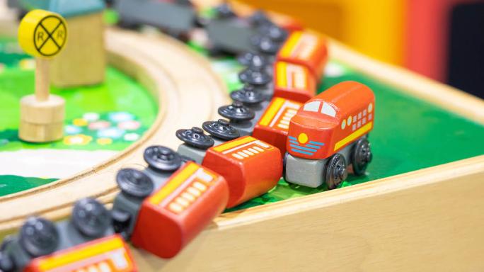 A toy train coming off the rails