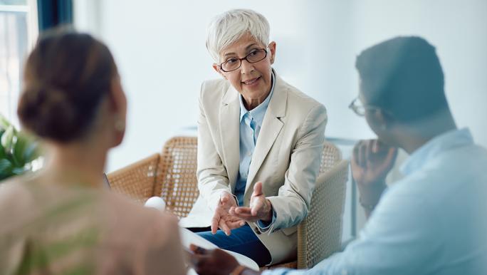 Couple discussing pension options with expert
