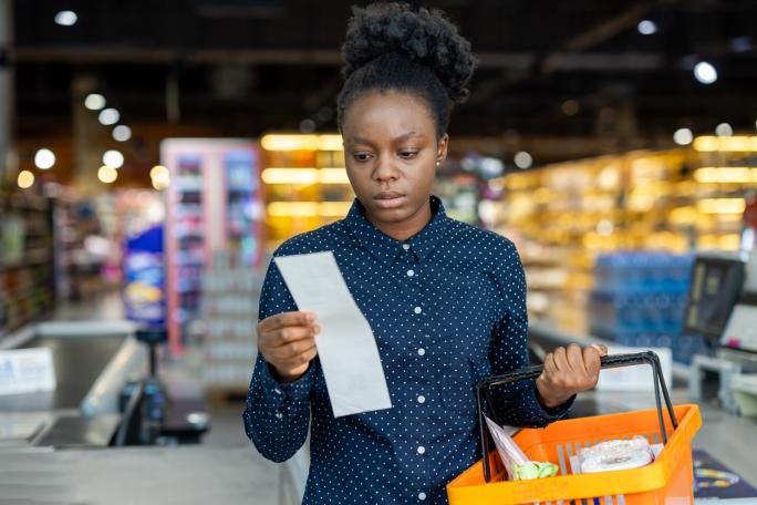 Woman checking her receipt after shopping