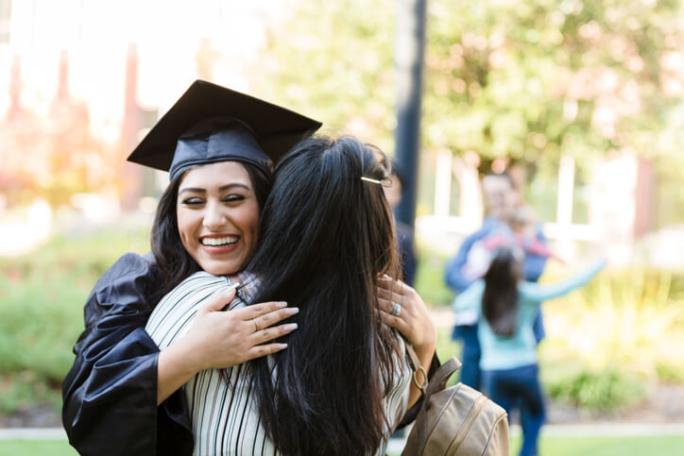 daughter hugging mother at graduation