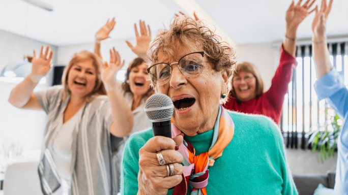 Group of elderly woman doing karaoke