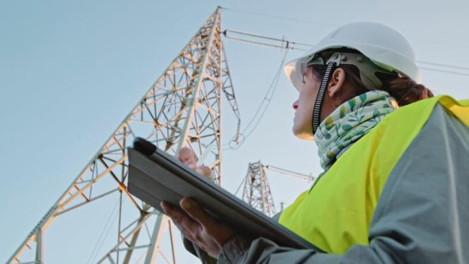 engineer inspecting electrical pylon