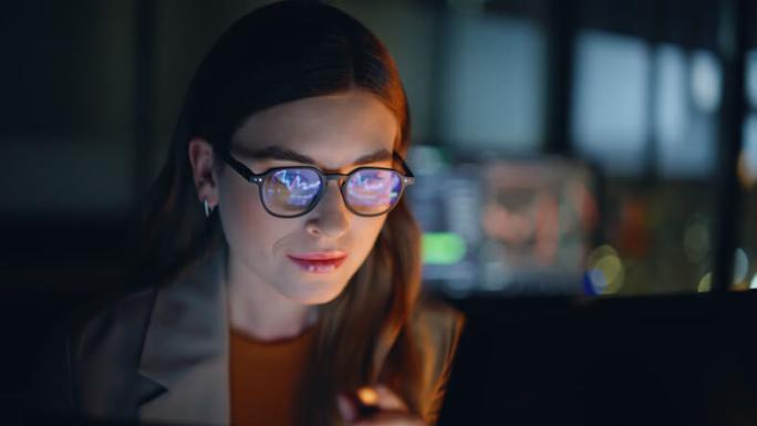female stockbroker reviewing charts on computer screen