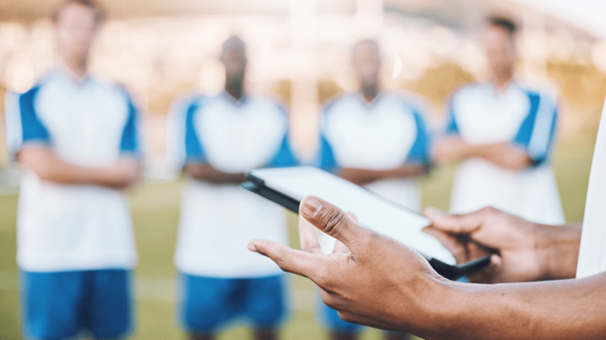 Footballers in a circle with manager