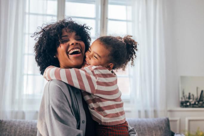 happy child hugging smiling mum