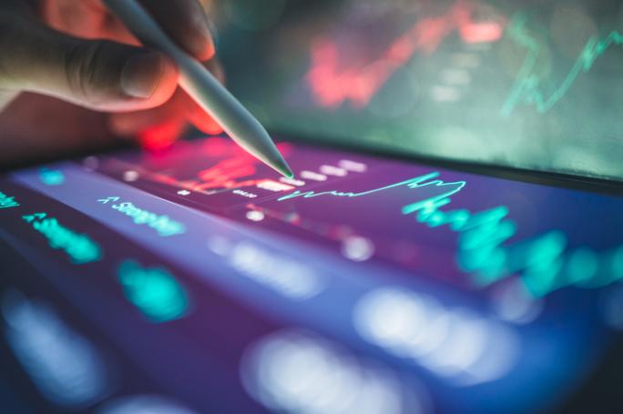 investor reviewing financial dashboard with graphs