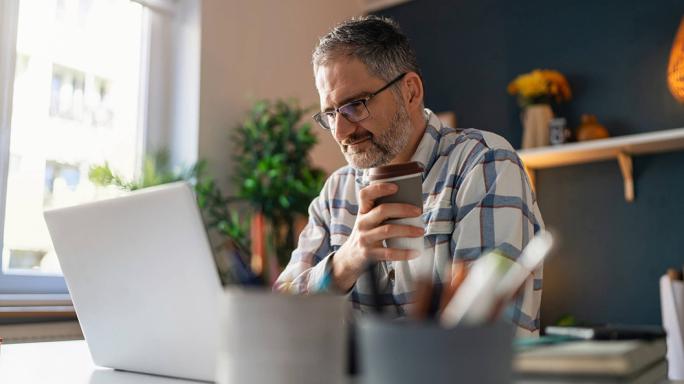 Man sitting looking at laptop 