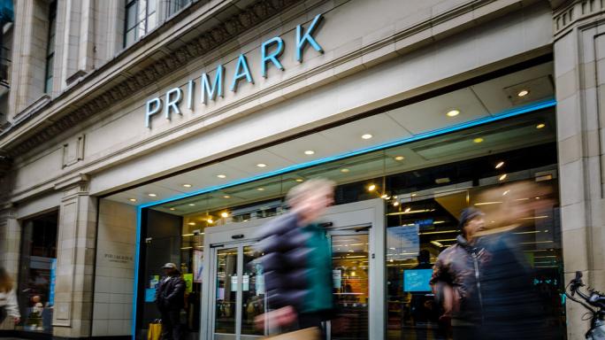 people walking past primark on the high street