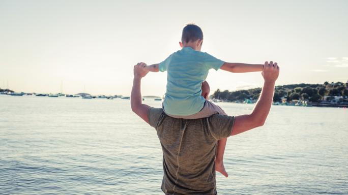 child on parent's shoulders