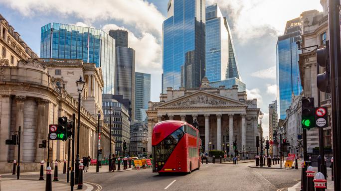 red london doubledecker bus in front of the london stock exchange