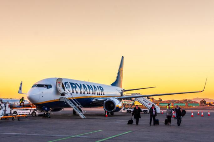 ryanair plane at airport during sunset