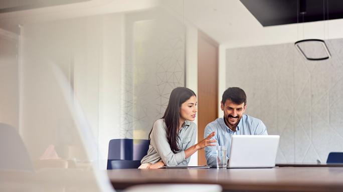 two business people using laptop