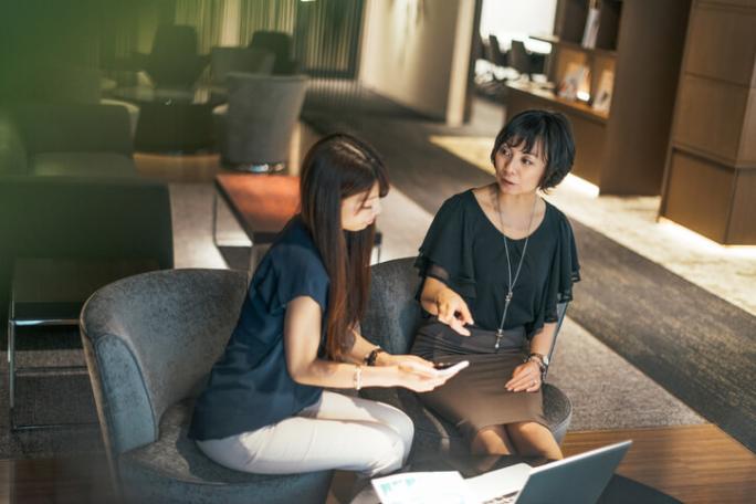 two women discussing in a modern office