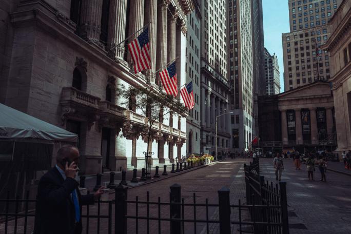 us flags on building in financial district in new york