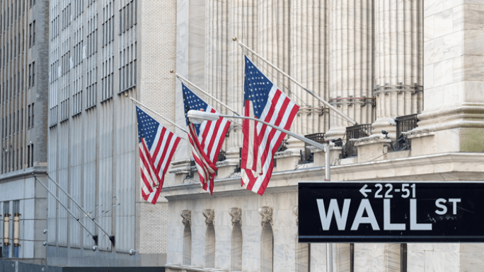 us flags on wall street building