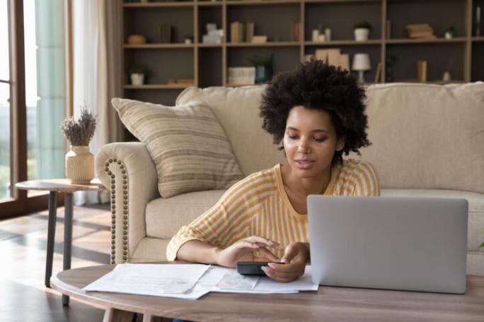 woman doing her finances in the living room at home