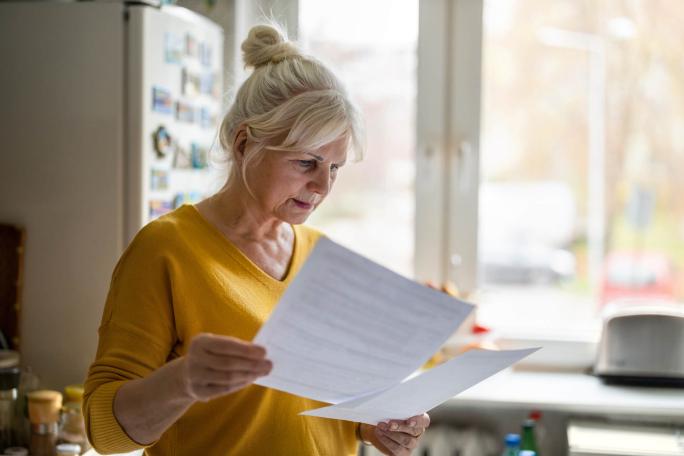 woman going through paperwork in the kitchen