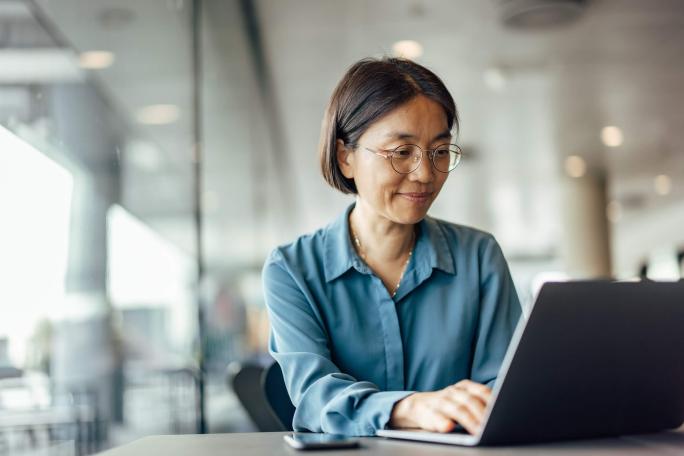 woman smiling using laptop
