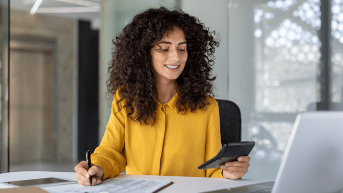 Woman on a laptop using a calculator
