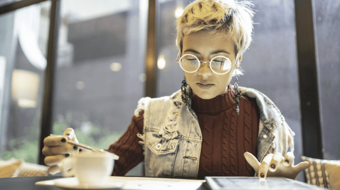 Woman studying notes and a tablet