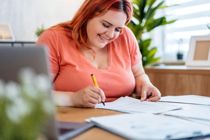 young woman filling in paper applications