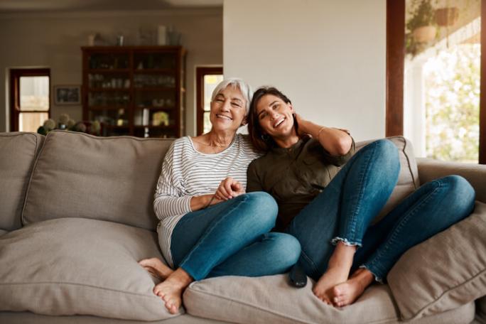 young woman sitting on sofa with mum