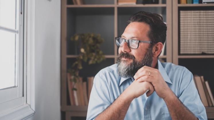 Man looking out window