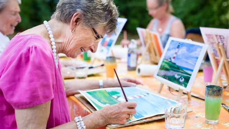 Retired people having fun painting