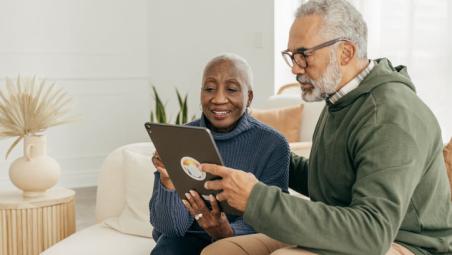 couple-using-ipad-together-sitting-on-a-sofa-in-a-neutral-home.jpg