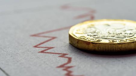 downward-graph-on-paper-with-pound-coin-on-top.jpg