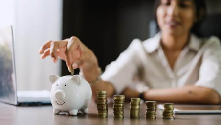 woman-putting-coins-in-piggy-bank.jpg