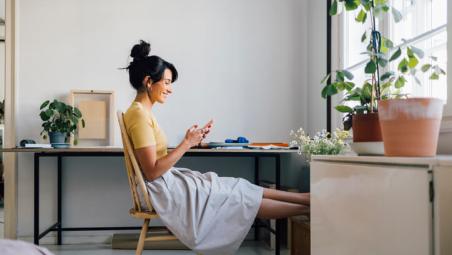 woman-using-her-phone-while-sitting-in-front-of-a-desk.jpg