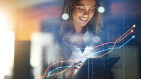 woman-using-tablet-with-increasing-graph-in-front.jpg