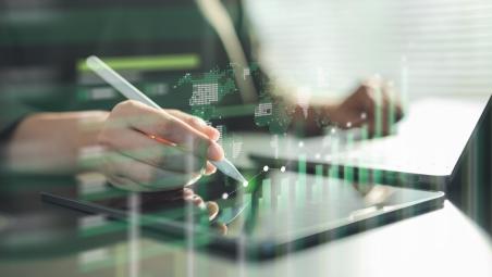 A hand using a digital pen on a tablet