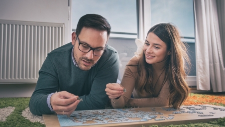 Couple having fun with puzzle