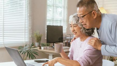 Elderly couple at computer